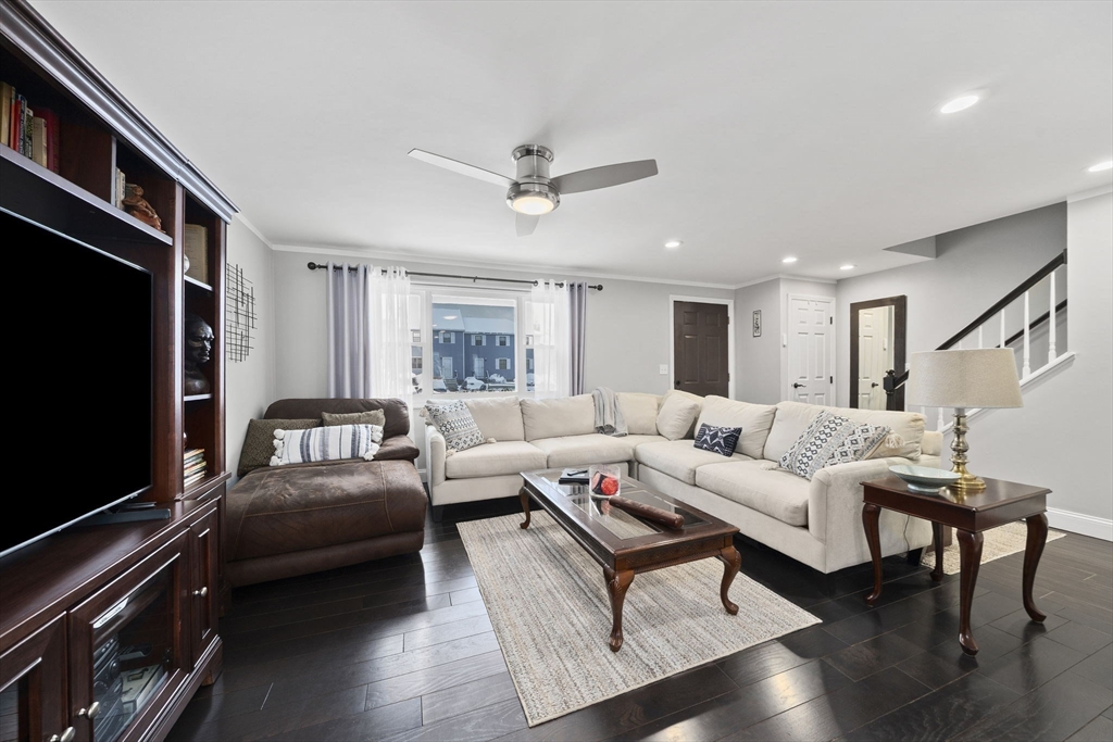 4 F Franklin Square, Unit 4F Randolph, MA 02368 - Photo 2 of 26 a living room with furniture and a flat screen tv