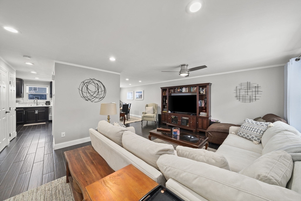 4 F Franklin Square, Unit 4F Randolph, MA 02368 - Photo 5 of 26 a living room with furniture and a flat screen tv