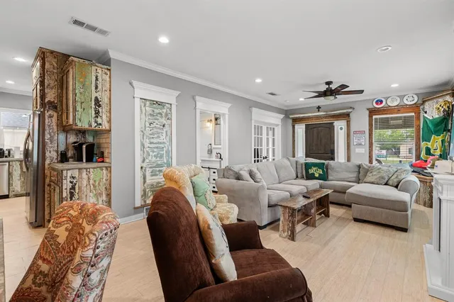 a living room with furniture potted plant and a large window