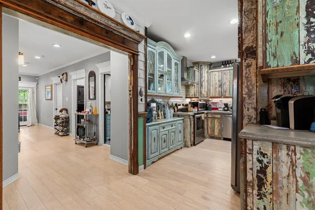 a kitchen with refrigerator and cabinets