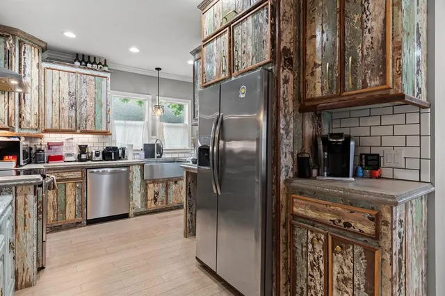 a kitchen with a refrigerator a sink and cabinets