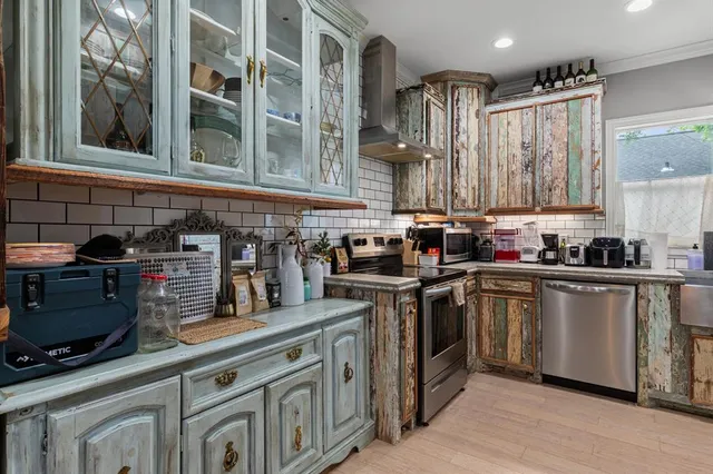 a kitchen with stainless steel appliances granite countertop a stove and a sink