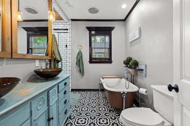 a bathroom with a toilet sink and mirror