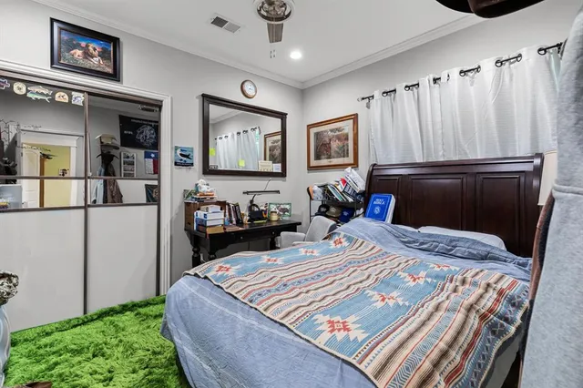 a bedroom with a bed and a refrigerator