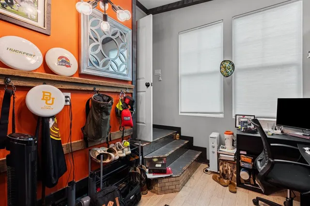 a view of a workspace with furniture and a window