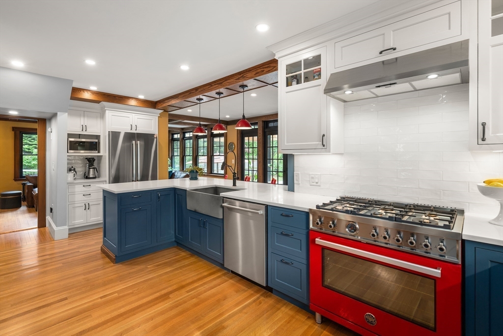76 Cliff Road Milton, MA 02186 - Photo 12 of 36 a kitchen with stainless steel appliances granite countertop a stove and a wooden floors