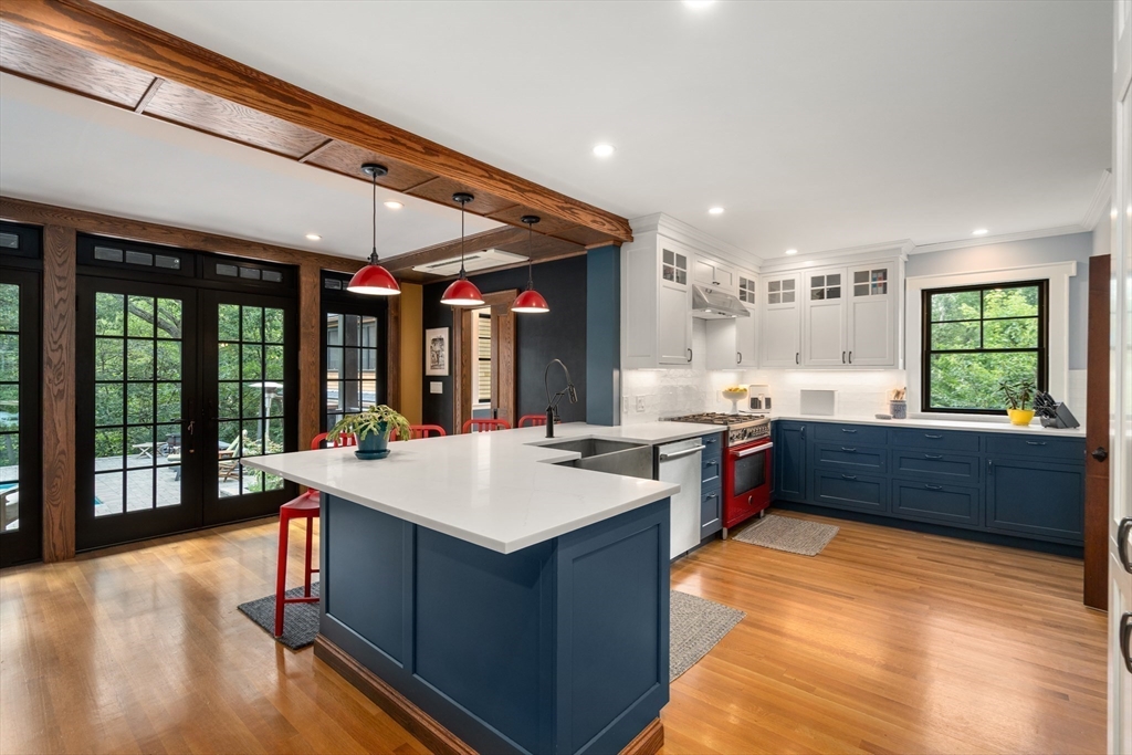 76 Cliff Road Milton, MA 02186 - Photo 13 of 36 a large kitchen with kitchen island a large island in it