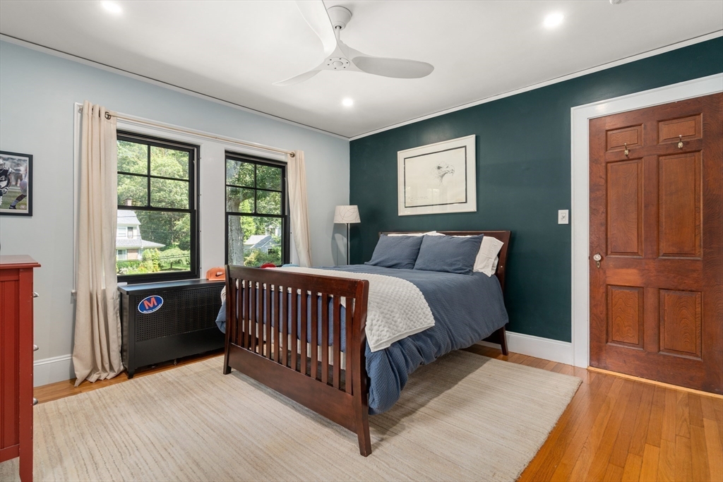 76 Cliff Road Milton, MA 02186 - Photo 21 of 36 a bed sitting in a spacious bedroom next to a window