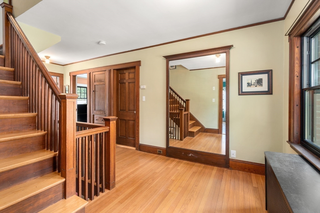 76 Cliff Road Milton, MA 02186 - Photo 22 of 36 a view of a hallway with wooden floor and staircase