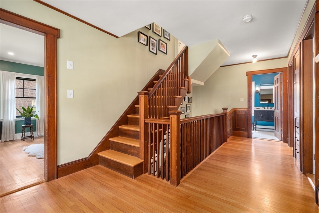 76 Cliff Road Milton, MA 02186 - Photo 23 of 36 a view of a hallway with wooden floor and stairs