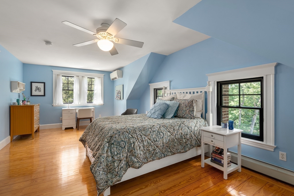 76 Cliff Road Milton, MA 02186 - Photo 24 of 36 a bedroom with a bed and wooden floor