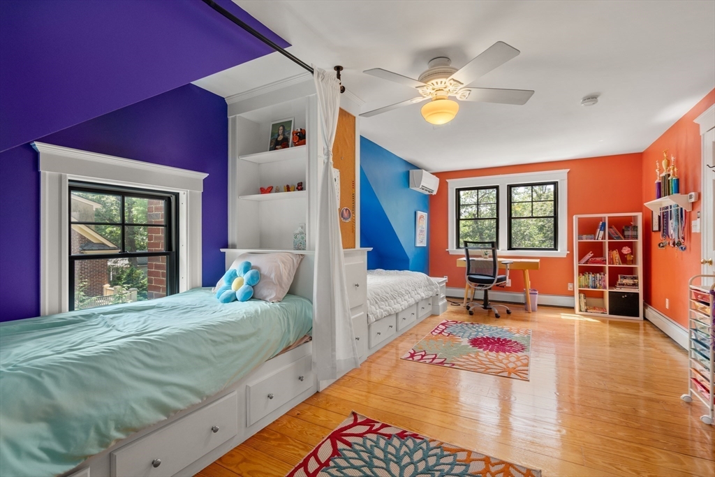 76 Cliff Road Milton, MA 02186 - Photo 26 of 36 a bed room with a bed and a chandelier