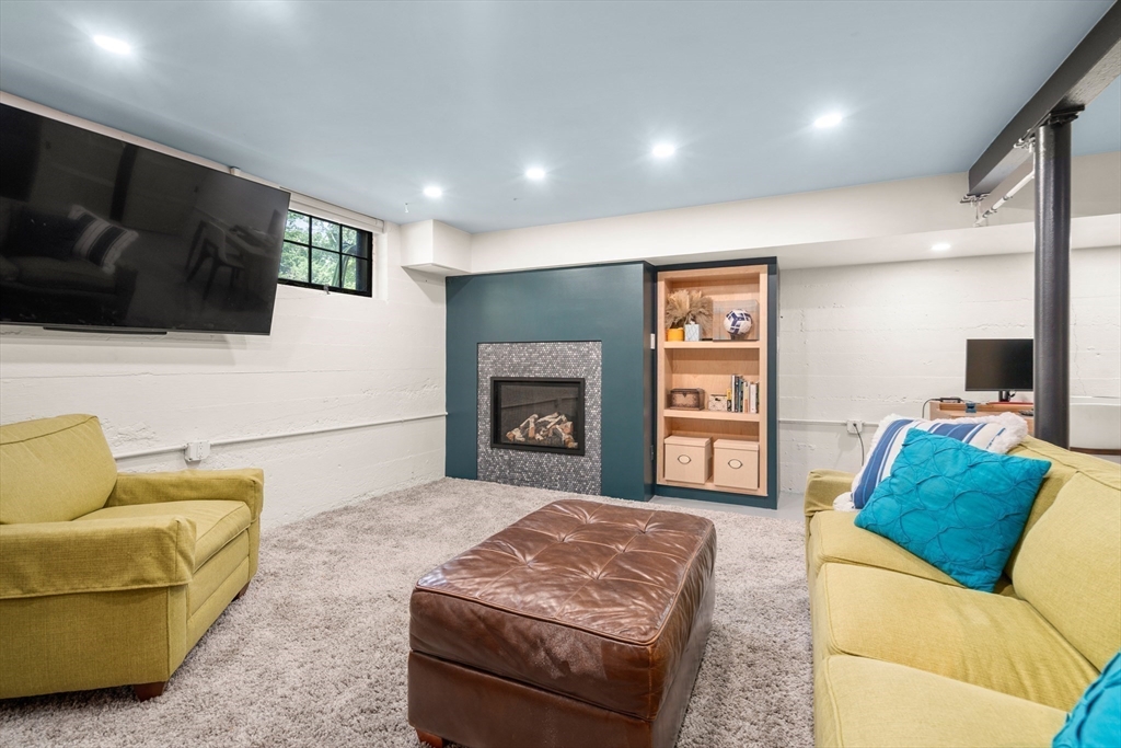 76 Cliff Road Milton, MA 02186 - Photo 27 of 36 a living room with furniture and a flat screen tv