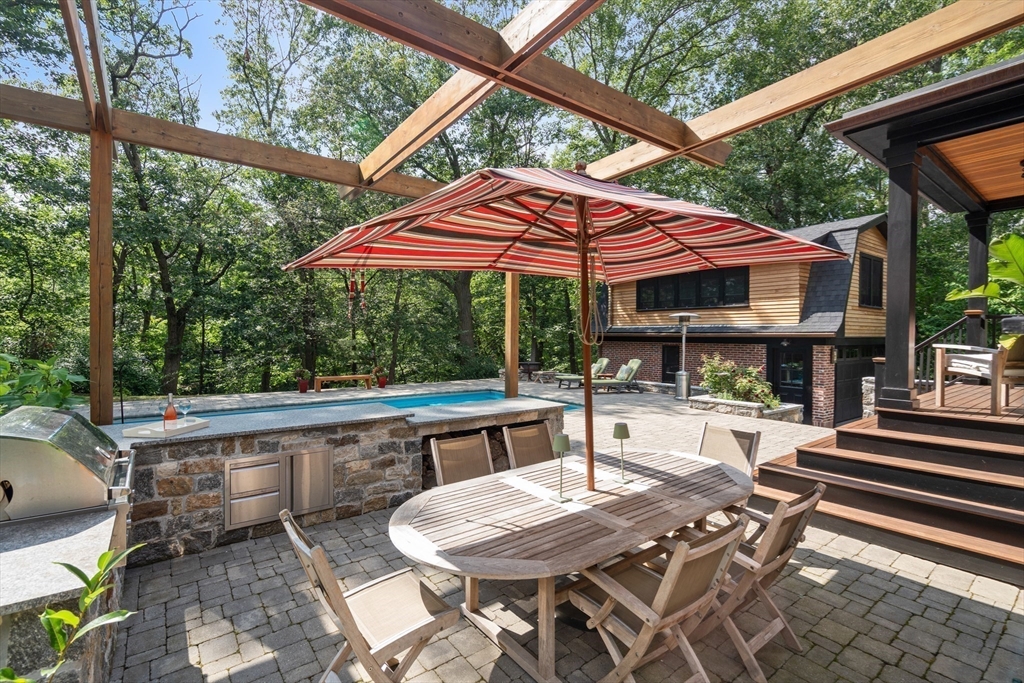 76 Cliff Road Milton, MA 02186 - Photo 31 of 36 a view of backyard with outdoor seating a patio and a garden