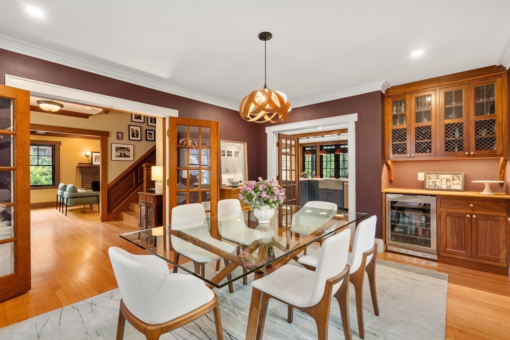 76 Cliff Road Milton, MA 02186 - Photo 10 of 36 a dining room with wooden floor a chandelier a wooden table and chairs