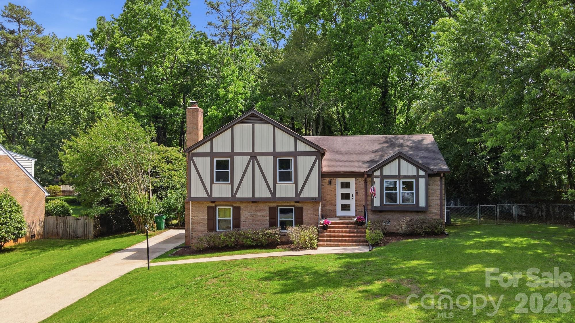 824 Riverwood Road Charlotte, NC 28270 - Photo 37 of 37 a house that is sitting in the grass with large trees and plants