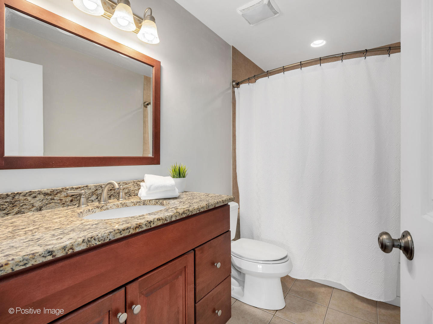 4313 Eberly Avenue Brookfield, IL 60513 - Photo 15 of 22 a bathroom with a granite countertop sink toilet and mirror