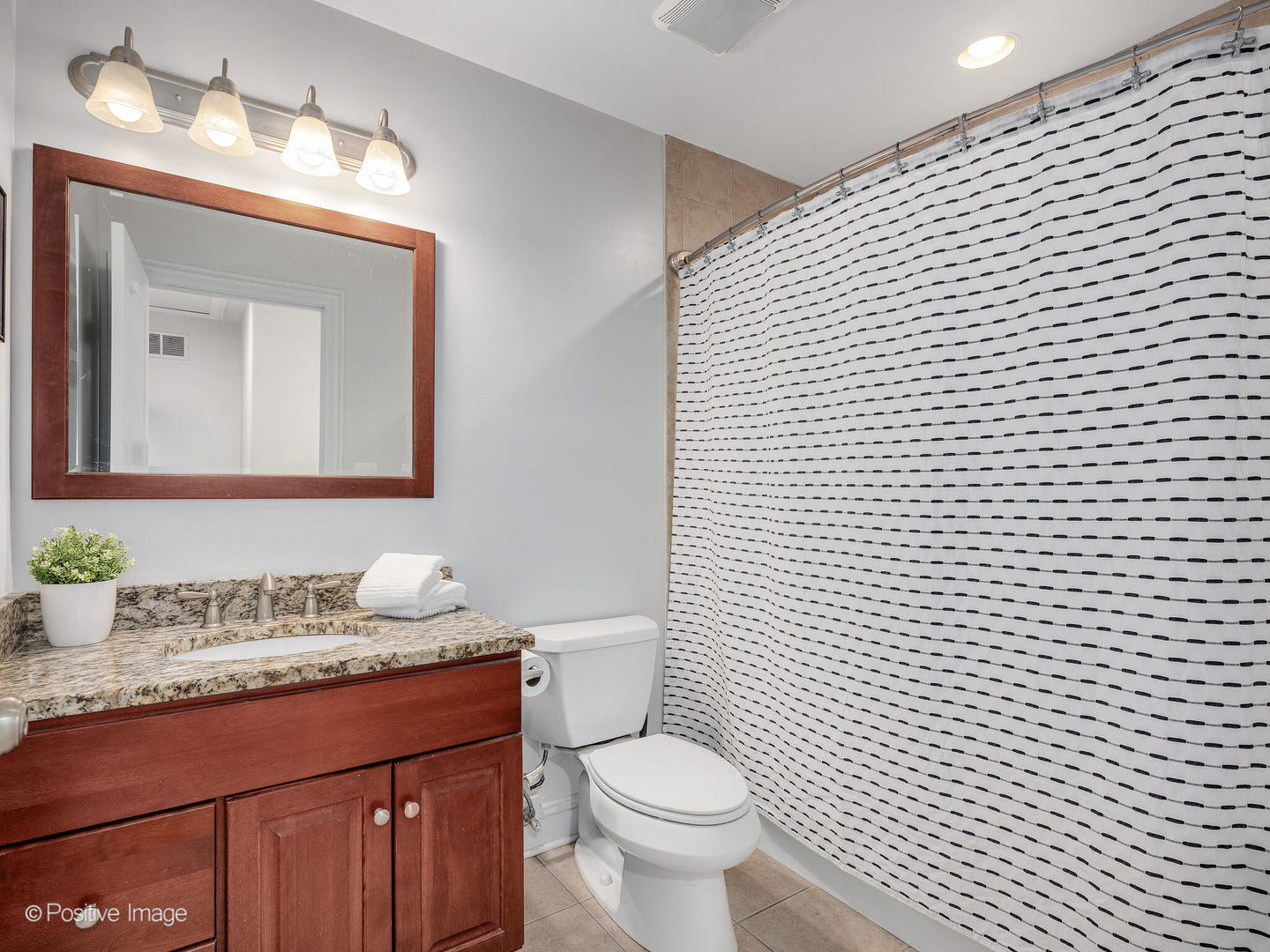4313 Eberly Avenue Brookfield, IL 60513 - Photo 18 of 22 a bathroom with a granite countertop toilet sink and mirror