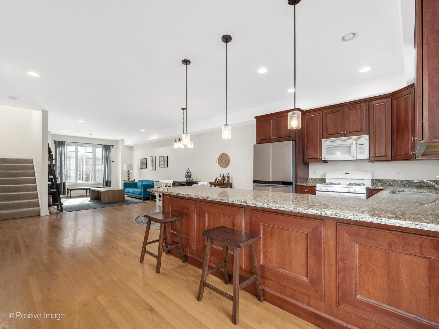 4313 Eberly Avenue Brookfield, IL 60513 - Photo 9 of 22 a kitchen with stainless steel appliances granite countertop sink microwave and wooden floor