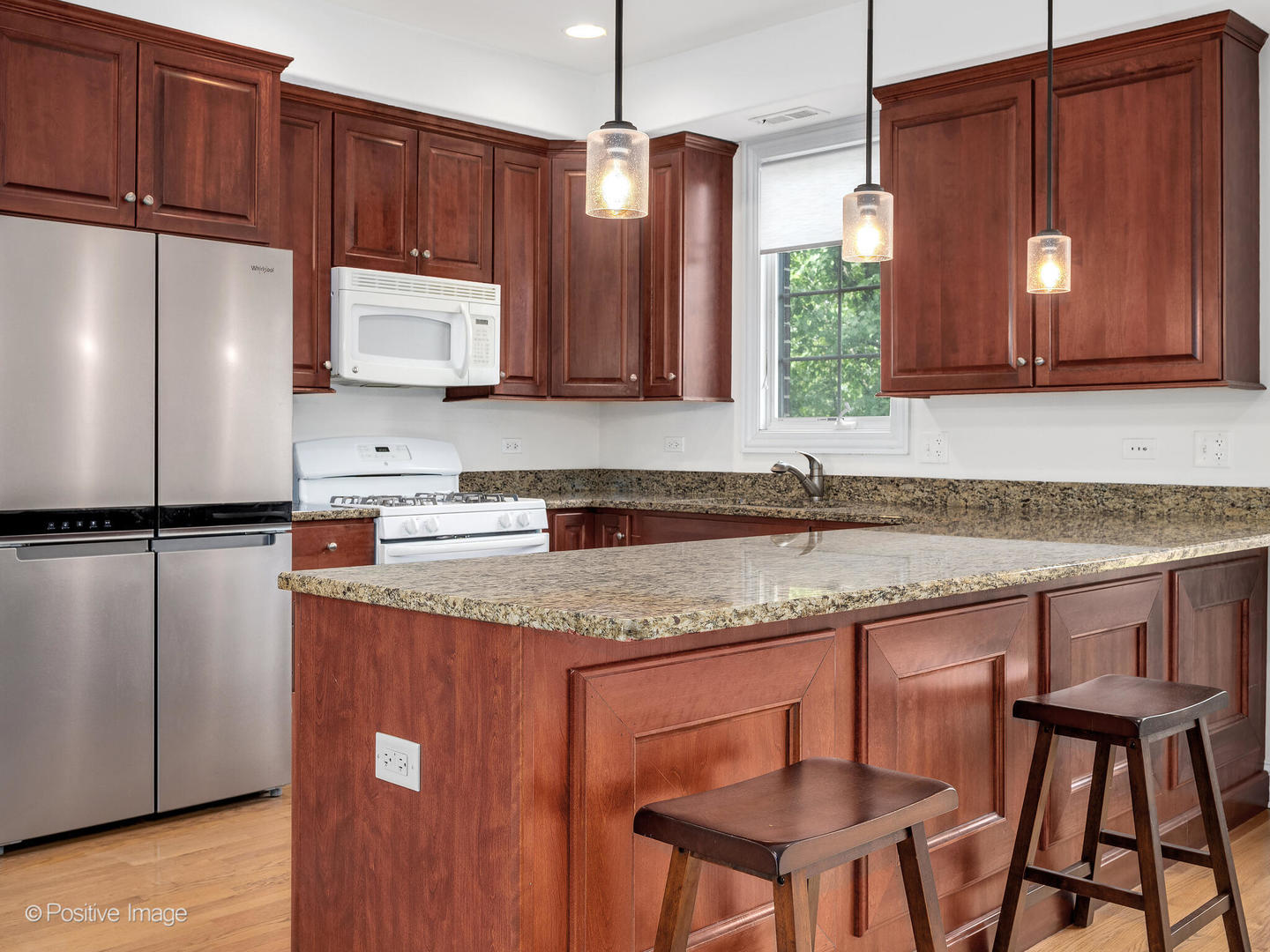 4313 Eberly Avenue Brookfield, IL 60513 - Photo 10 of 22 a kitchen with stainless steel appliances granite countertop a sink refrigerator and microwave