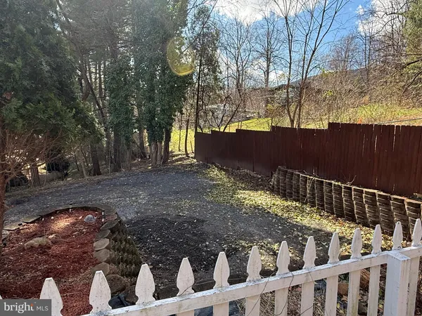 a view of street with wooden fence
