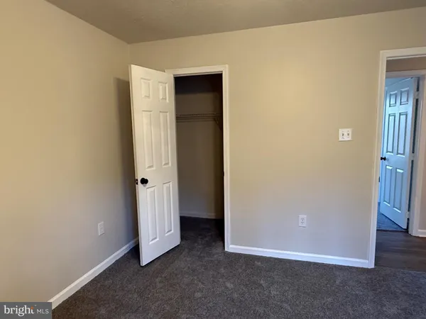 an empty room with closet area