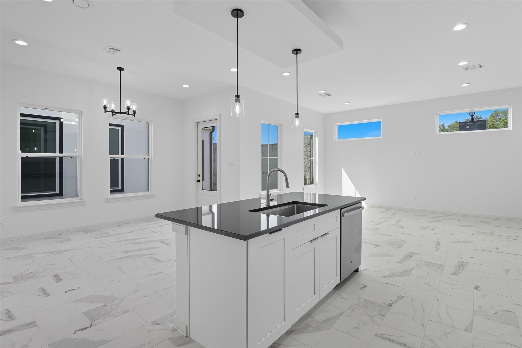 2924 El Fenice Lane Houston, TX 77057 - Photo 11 of 39 a kitchen with stainless steel appliances granite countertop a sink a counter top space cabinets and a chandelier