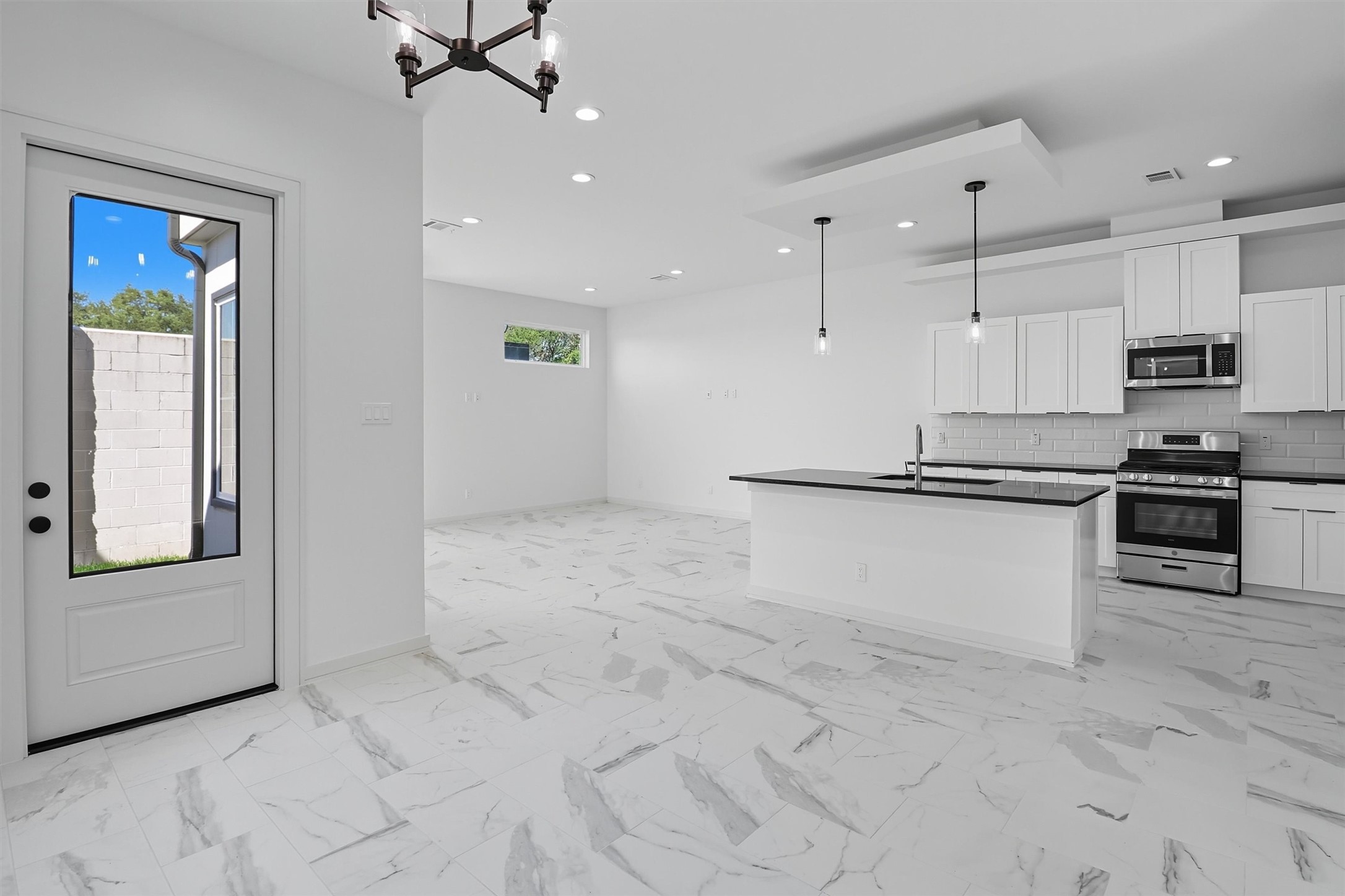 2924 El Fenice Lane Houston, TX 77057 - Photo 14 of 39 a kitchen with granite countertop a refrigerator and a stove top oven