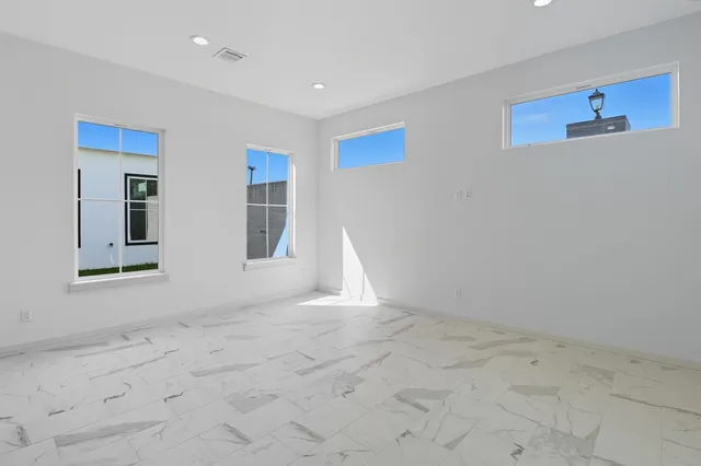 an empty room with windows and closet