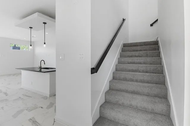 a bathroom with a granite countertop sink mirror bathtub and toilet