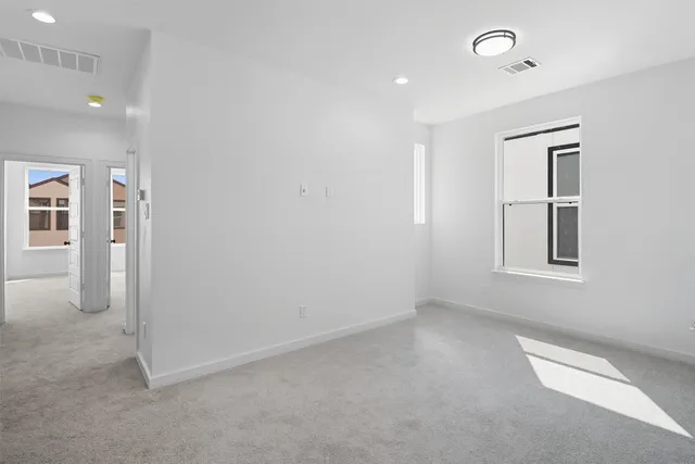 a spacious bathroom with a double vanity sink a mirror and a bathtub