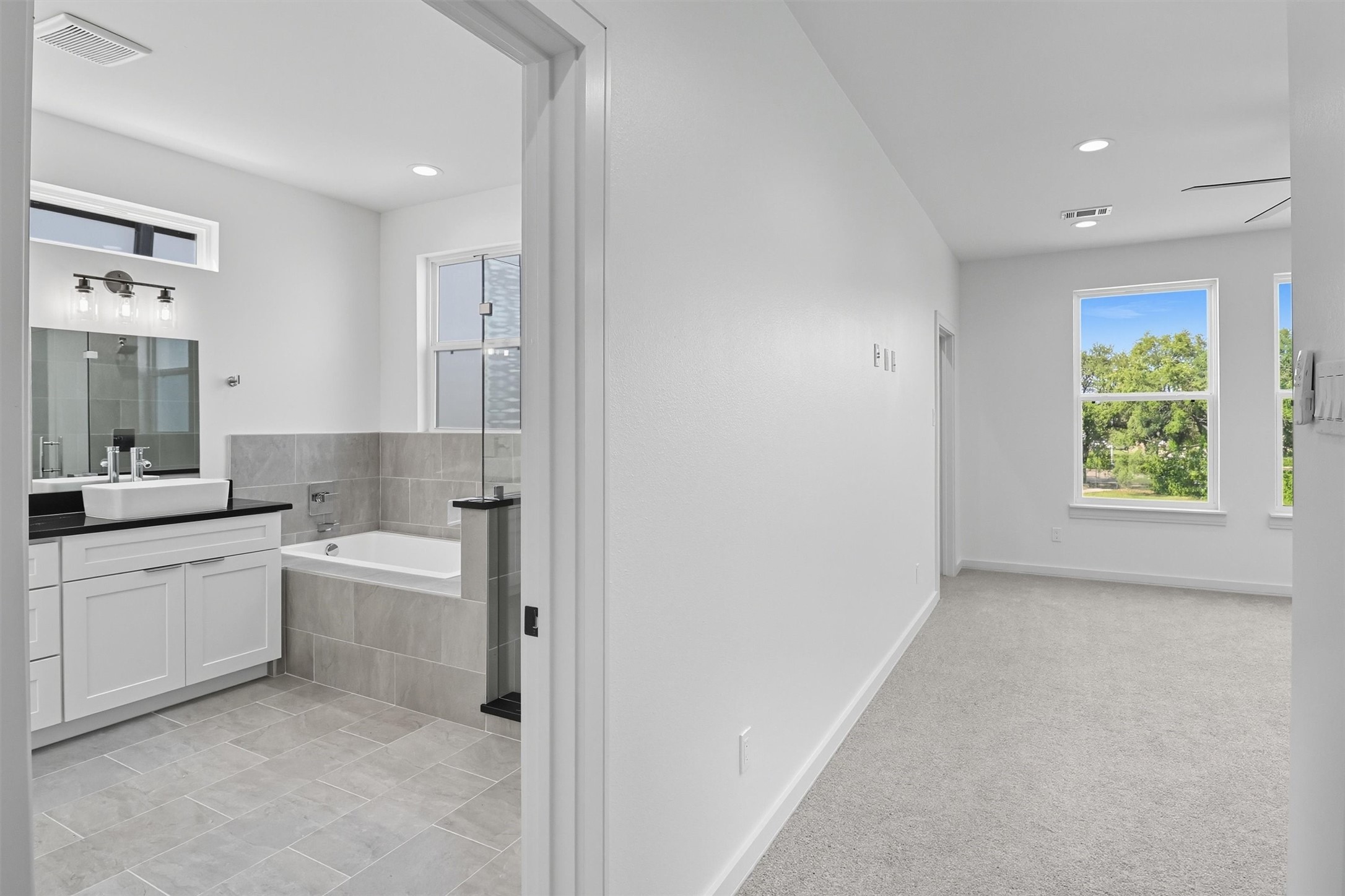 2924 El Fenice Lane Houston, TX 77057 - Photo 22 of 39 a bathroom with a granite countertop sink mirror bathtub and toilet