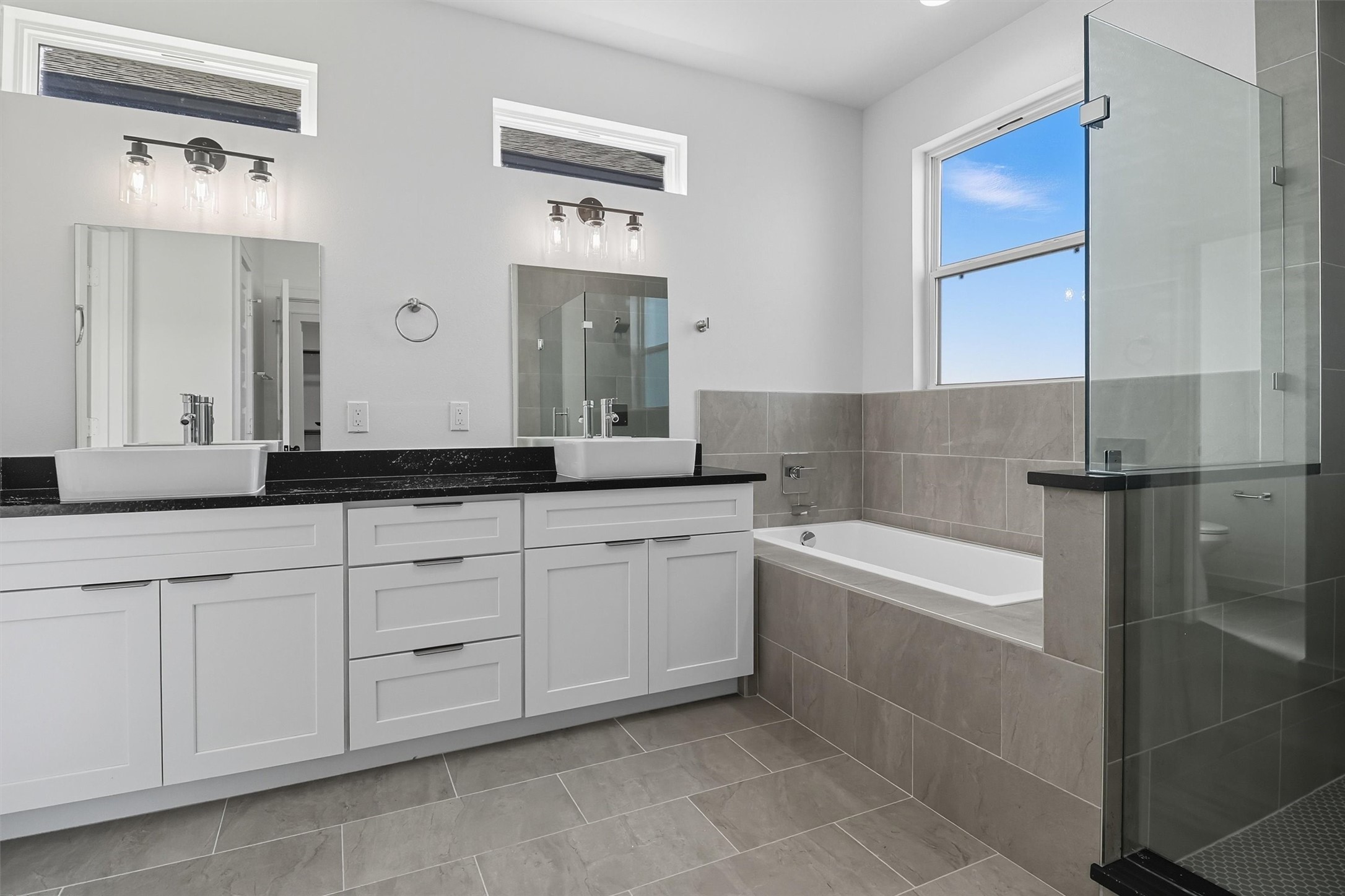 2924 El Fenice Lane Houston, TX 77057 - Photo 25 of 39 a spacious bathroom with a double vanity sink a mirror and a bathtub