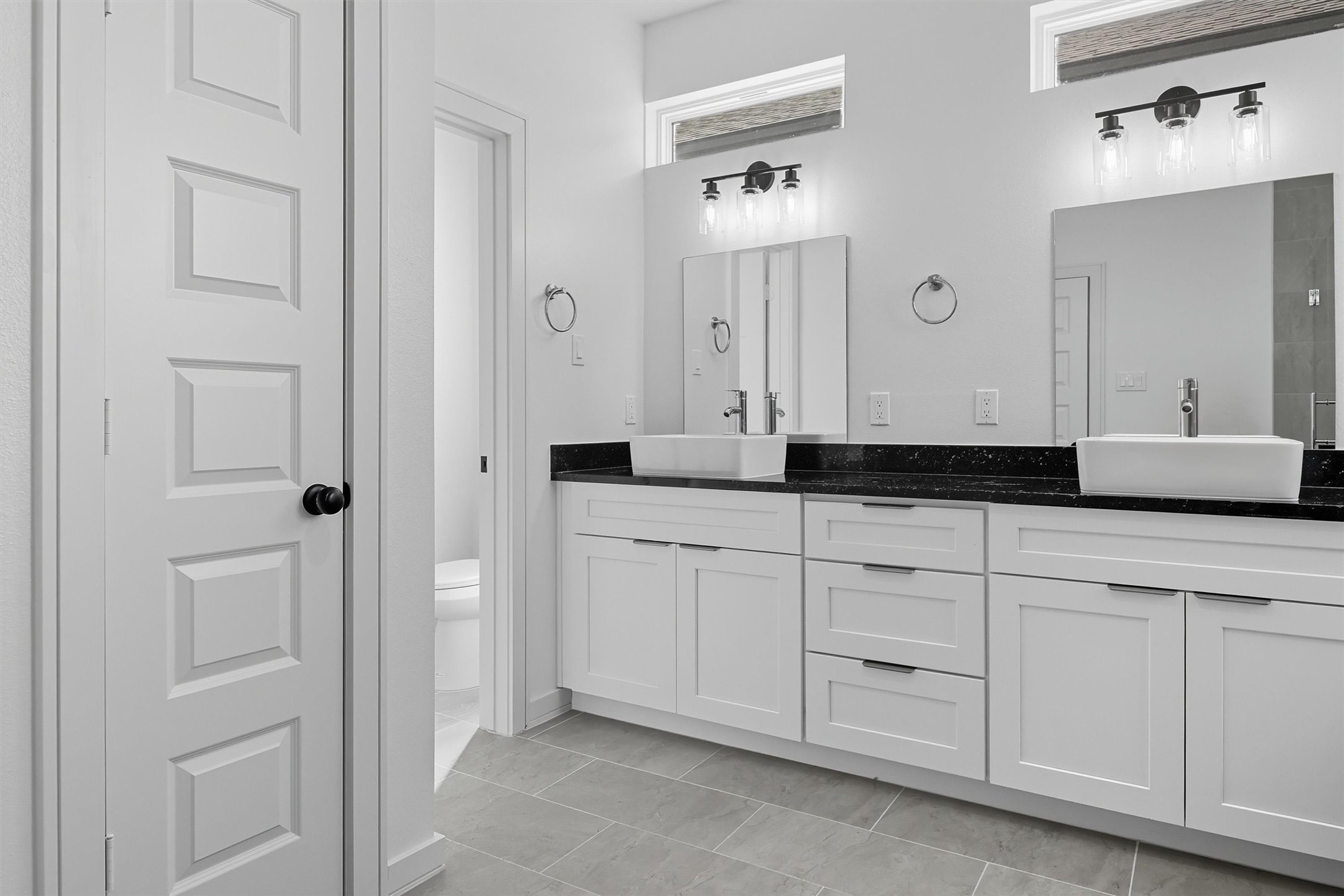 2924 El Fenice Lane Houston, TX 77057 - Photo 27 of 39 An alternate view of the vanity
showcases the upper windows,
which fill the space with natural light
while maintaining privacy.