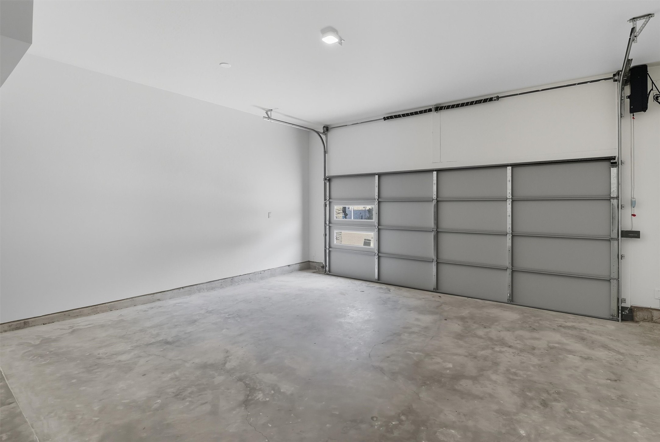 2924 El Fenice Lane Houston, TX 77057 - Photo 38 of 39 The garage also features a Wi-Fi-enabled door system for convenient, modern access. You have windows on the garage door that allows natural light to shine through.