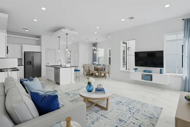 a kitchen with stainless steel appliances granite countertop a sink a counter top space cabinets and a chandelier