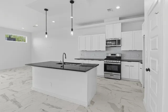 a view of a hallway with chandelier and entryway