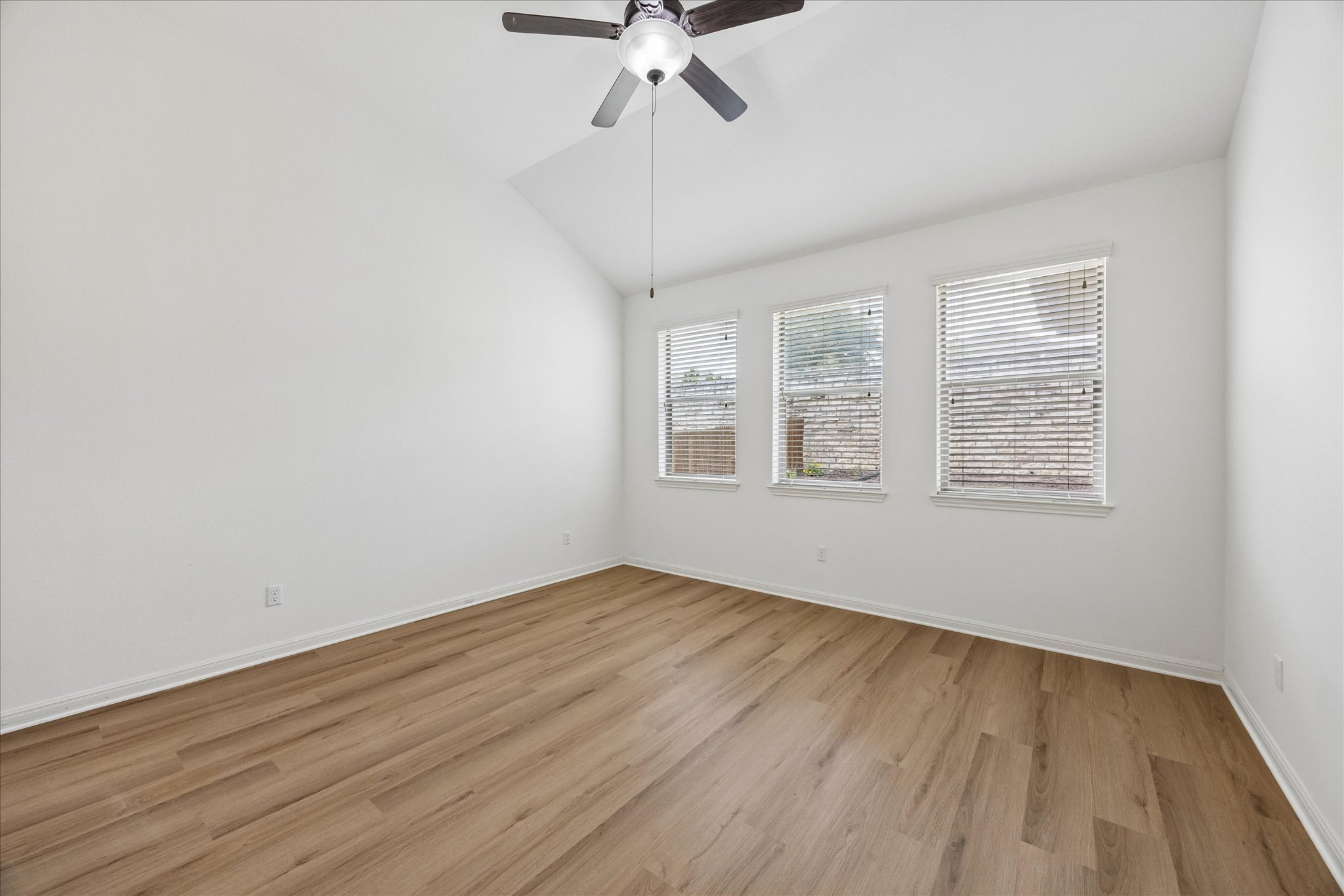 14304 Senia Bend Austin, TX 78738 - Photo 9 of 15 Bright and light bedroom with vaulted ceilings and new flooring (June 2026)