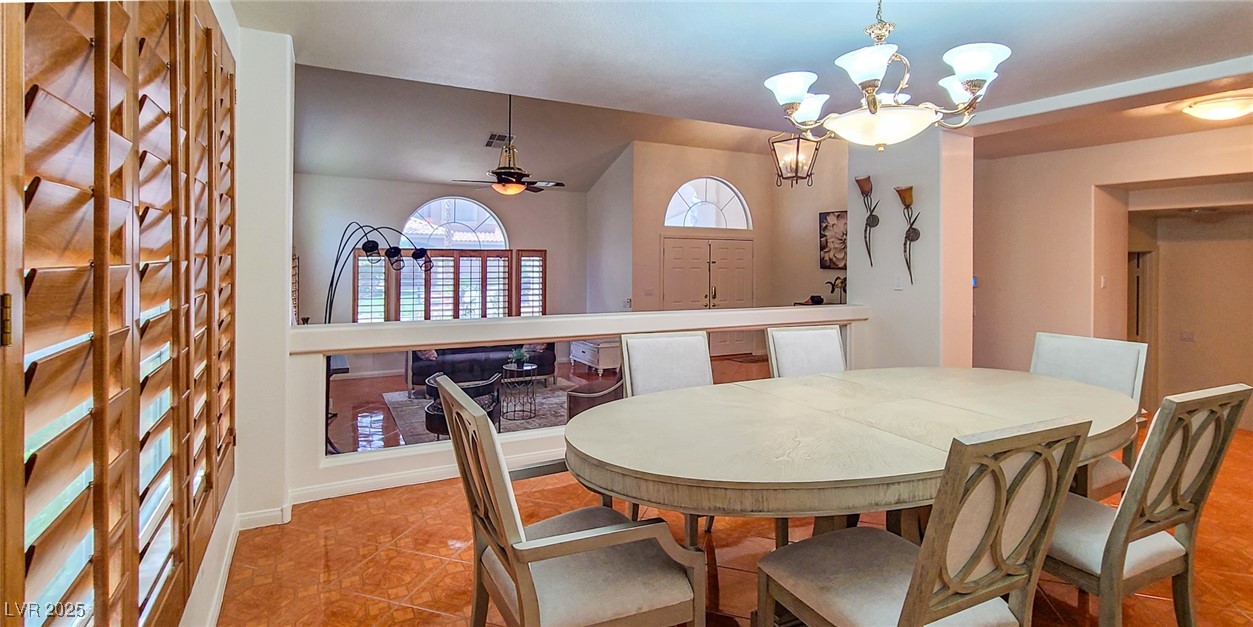 4100 Highland Castle Court Las Vegas, NV 89129 - Photo 15 of 49 Dining space featuring a chandelier and a ceiling fan