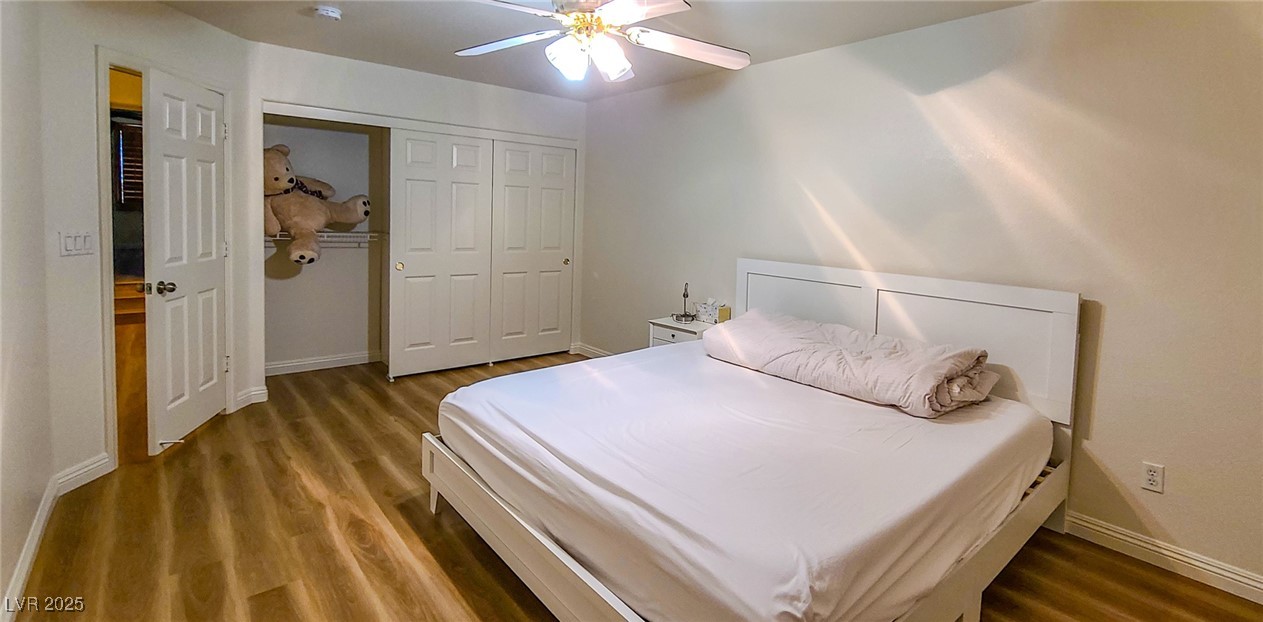 4100 Highland Castle Court Las Vegas, NV 89129 - Photo 17 of 49 Bedroom featuring dark wood-style flooring, a closet, and ceiling fan
