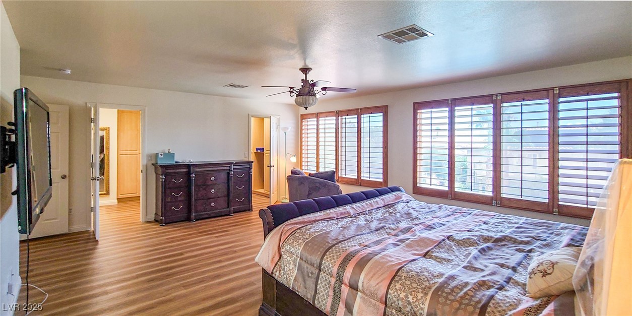 4100 Highland Castle Court Las Vegas, NV 89129 - Photo 26 of 49 Bedroom featuring wood finished floors and a ceiling fan