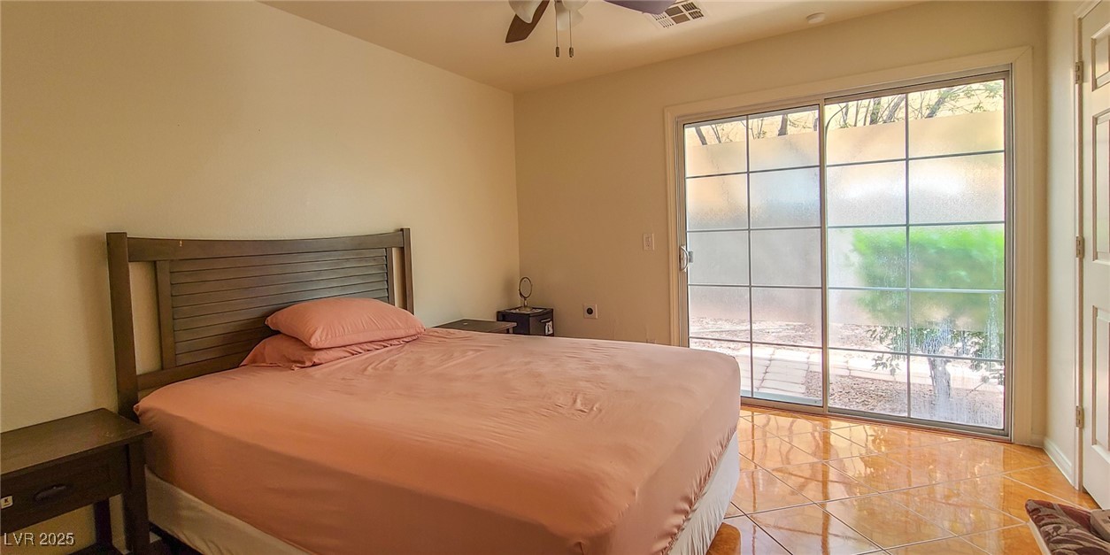 4100 Highland Castle Court Las Vegas, NV 89129 - Photo 40 of 49 Bedroom featuring access to outside, ceiling fan, and light tile patterned floors