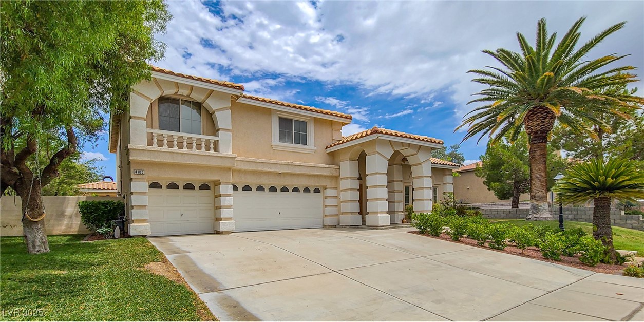 4100 Highland Castle Court Las Vegas, NV 89129 - Photo 47 of 49 Mediterranean / spanish-style house featuring stucco siding, a garage, driveway, a tiled roof, and a balcony