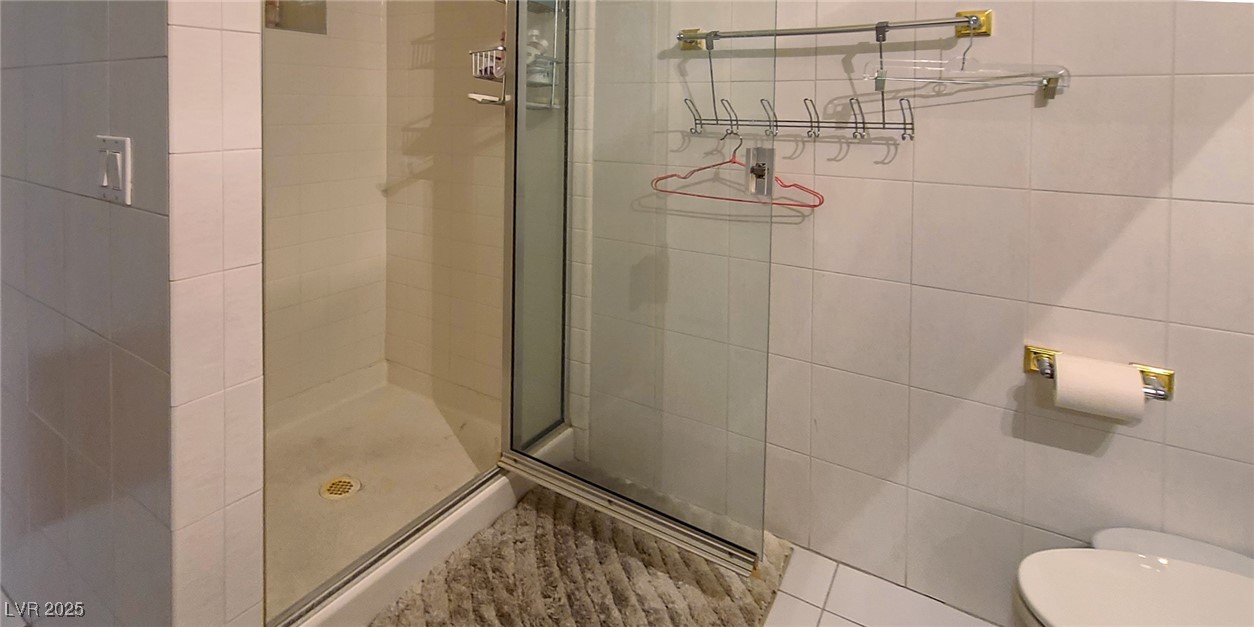 4100 Highland Castle Court Las Vegas, NV 89129 - Photo 8 of 49 Full bath with a shower stall and tile walls
