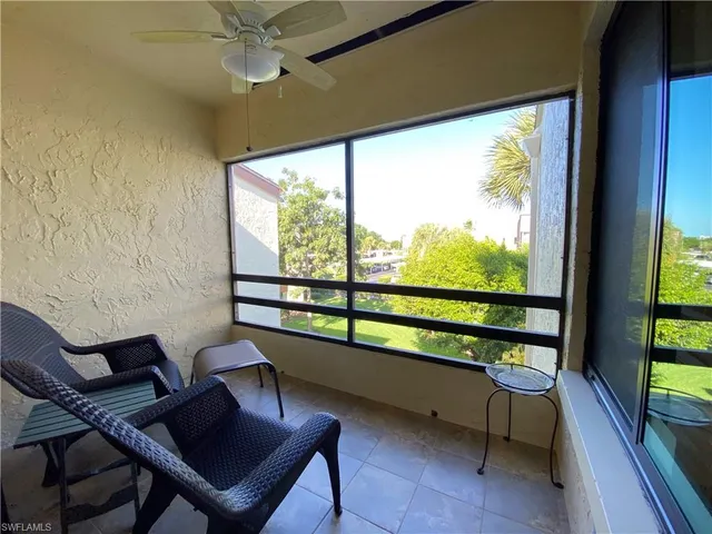 a view of a porch with furniture and a balcony