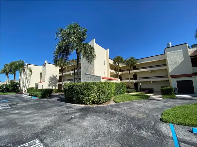 a view of a house with a yard and potted plants
