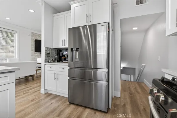 a kitchen with stainless steel appliances a refrigerator sink and cabinets