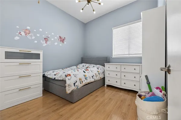 a bedroom with a bed and a chandelier