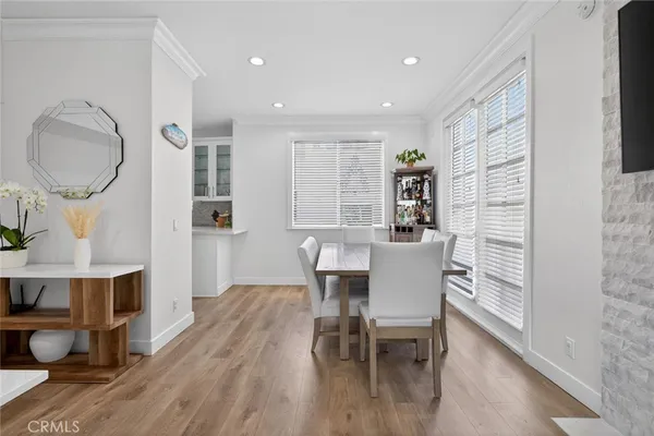 a dining room with furniture and wooden floor