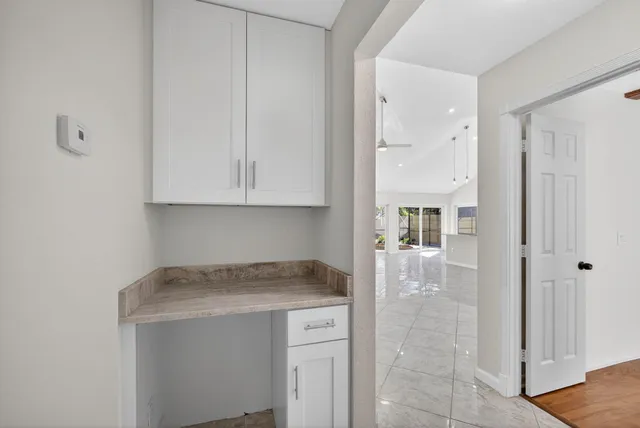 a view of kitchen cabinets and wooden floor